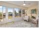 Bright sun room with tile floor, ceiling fan, and large windows with views of the backyard at 10071 Sw 90Th Loop, Ocala, FL 34481