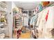 Walk-in closet featuring built-in shelving and wooden floors at 10071 Sw 90Th Loop, Ocala, FL 34481