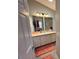 Bathroom with an extended countertop, white cabinets and drawers, and a large mirror at 1118 Pelion Pl, The Villages, FL 32162