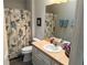 Bathroom with a shower-tub combo featuring a patterned curtain, a white vanity and framed mirror at 1118 Pelion Pl, The Villages, FL 32162
