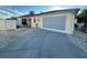 Home exterior with a well-maintained driveway, attached garage, and manicured landscaping at 1118 Pelion Pl, The Villages, FL 32162