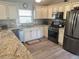 Well-equipped kitchen with stainless steel appliances, granite countertops, and plenty of storage at 1118 Pelion Pl, The Villages, FL 32162