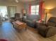 Inviting living room featuring hardwood floors, comfortable seating, and lots of natural light at 1118 Pelion Pl, The Villages, FL 32162