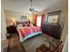 Serene main bedroom with a ceiling fan, hardwood floors, and natural light, offering a peaceful retreat at 1118 Pelion Pl, The Villages, FL 32162