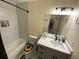 Well-lit bathroom with a shower over tub and a modern vanity at 1127 Enchanted Dr, Lakeland, FL 33801