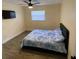 Cozy bedroom with ceiling fan and natural light from a window at 1127 Enchanted Dr, Lakeland, FL 33801