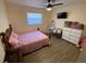 Cozy bedroom with a window, ceiling fan, and hardwood floors at 1127 Enchanted Dr, Lakeland, FL 33801