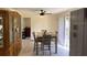 Bright dining room with a ceiling fan, storage cabinet, and sliding glass door at 1127 Enchanted Dr, Lakeland, FL 33801
