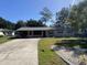 Charming single-story home with a well-maintained front lawn and long driveway at 1127 Enchanted Dr, Lakeland, FL 33801