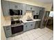 Modern kitchen featuring stainless steel appliances and sleek gray cabinetry at 1127 Enchanted Dr, Lakeland, FL 33801
