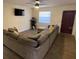 Comfortable living room with a large sectional sofa and a ceiling fan at 1127 Enchanted Dr, Lakeland, FL 33801