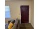 Inviting living room featuring a modern door and a large window with blinds at 1127 Enchanted Dr, Lakeland, FL 33801