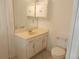 Bathroom featuring a vanity with ample storage, toilet, mirror, medicine cabinet and tile flooring at 11665 Sw 72Nd Cir, Ocala, FL 34476