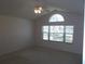 Bright bedroom with vaulted ceiling, fan, and natural light through a large window at 11665 Sw 72Nd Cir, Ocala, FL 34476