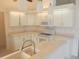Bright kitchen showcasing updated appliances and ample counter space, with white cabinetry at 11665 Sw 72Nd Cir, Ocala, FL 34476