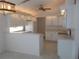 Well-lit kitchen featuring ample counter space, pendant lighting and white cabinetry at 11665 Sw 72Nd Cir, Ocala, FL 34476