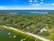 Scenic aerial shot of a waterfront property featuring docks and lush surrounding greenery near the lake at 12336 E Highway 25, Ocklawaha, FL 32179