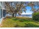 Picturesque waterfront property features a spacious yard that slopes down to the lake and private dock at 12336 E Highway 25, Ocklawaha, FL 32179
