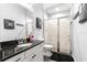 This bathroom features a glass enclosed shower, vanity, and decorative mirror at 12336 E Highway 25, Ocklawaha, FL 32179