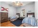Bright bedroom with two twin beds, stylish decor, wood floors and plenty of natural light at 12336 E Highway 25, Ocklawaha, FL 32179