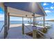 Covered boat dock on the water with rope accents and a boat lift for easy access at 12336 E Highway 25, Ocklawaha, FL 32179