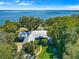 A luxurious waterfront home with a metal roof and mature landscaping, offering breathtaking views of the lake at 12336 E Highway 25, Ocklawaha, FL 32179