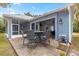 This home features a covered patio and outdoor dining set at 12336 E Highway 25, Ocklawaha, FL 32179