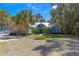 Beautiful home featuring stone accents, a metal roof, and mature palm trees at 12336 E Highway 25, Ocklawaha, FL 32179