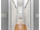 Hallway view leading into the main bathroom, featuring wood laminate flooring at 12336 E Highway 25, Ocklawaha, FL 32179