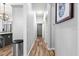 Long hallway with natural light featuring wood-look floors and neutral paint at 12336 E Highway 25, Ocklawaha, FL 32179