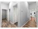 Hallway with multiple doorways leading to different rooms and durable wood laminate flooring at 12336 E Highway 25, Ocklawaha, FL 32179
