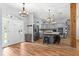 Open floor plan with kitchen island, stainless steel appliances, and pendant lighting at 12336 E Highway 25, Ocklawaha, FL 32179