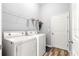 This laundry room features a washer, dryer, wire rack, and exterior door at 12336 E Highway 25, Ocklawaha, FL 32179