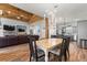 Open-concept living area with a dining table, kitchen, and a stone fireplace at 12336 E Highway 25, Ocklawaha, FL 32179