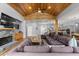 Expansive living room featuring a wood vaulted ceiling, stone fireplace, and open layout at 12336 E Highway 25, Ocklawaha, FL 32179