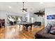 Open living room with pool table, lake view, ceiling fan, and leather couches; perfect for entertaining at 12336 E Highway 25, Ocklawaha, FL 32179