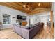 Inviting living room showcasing a vaulted wood ceiling, stone fireplace, and comfortable furnishings at 12336 E Highway 25, Ocklawaha, FL 32179