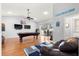 Well lit living room with a ceiling fan, pool table, and lake views at 12336 E Highway 25, Ocklawaha, FL 32179