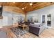 Open concept living room with hardwood floors, vaulted ceilings, and modern furnishings at 12336 E Highway 25, Ocklawaha, FL 32179