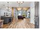 Open-concept living room featuring a stunning wood ceiling, hardwood floors, and water views at 12336 E Highway 25, Ocklawaha, FL 32179