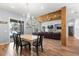 Open-concept living area with a dining table and sliding glass doors with lake views at 12336 E Highway 25, Ocklawaha, FL 32179