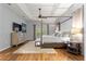 Spacious main bedroom features a four poster bed, tray ceilings, and lots of natural light at 12336 E Highway 25, Ocklawaha, FL 32179