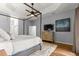 Bright main bedroom featuring a four poster bed, hard wood floors, and a light grey paint scheme at 12336 E Highway 25, Ocklawaha, FL 32179