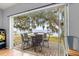 This patio is equipped with an outdoor dining set and a stunning lake view at 12336 E Highway 25, Ocklawaha, FL 32179