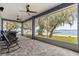 This screened porch overlooks a lake and features a seating and barbecue area at 12336 E Highway 25, Ocklawaha, FL 32179