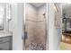 Stand up shower with glass enclosure, with a pebble floor detail and neutral ceramic walls at 12336 E Highway 25, Ocklawaha, FL 32179