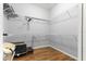 Spacious walk-in closet with wire shelving and wood-look flooring for optimal storage and organization at 12336 E Highway 25, Ocklawaha, FL 32179