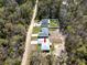 An aerial shot of a property nestled among trees, showcasing its layout, roof, and surrounding landscape at 12876 Se 42Nd Ct, Belleview, FL 34420