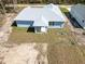 Aerial view showcasing the home's backyard, patio, and surrounding green space, blending comfort with nature at 12876 Se 42Nd Ct, Belleview, FL 34420