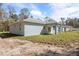 Rear exterior view of home with back patio, backyard, and blue paint at 12876 Se 42Nd Ct, Belleview, FL 34420